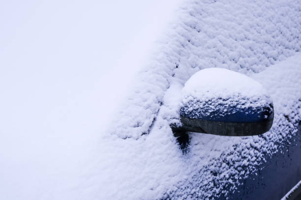istock Snow covered car in an open parking 1204245068