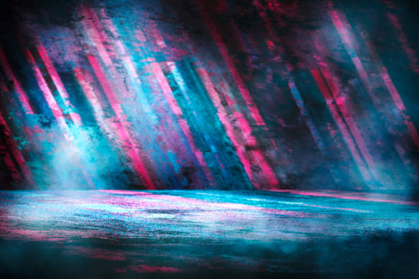 istock Dark empty stage, product showcase with futuristic multicolored rays of neon lights. 1204248085