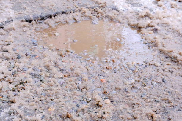 istock Paved road covered with melting snow 1204249205
