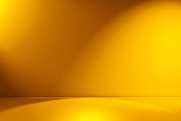 Beams of spotlight on a yellow background Yellow empty Studio room for product placement or as a design template with wall angle in a full frame view studio stock pictures, royalty-free photos & images