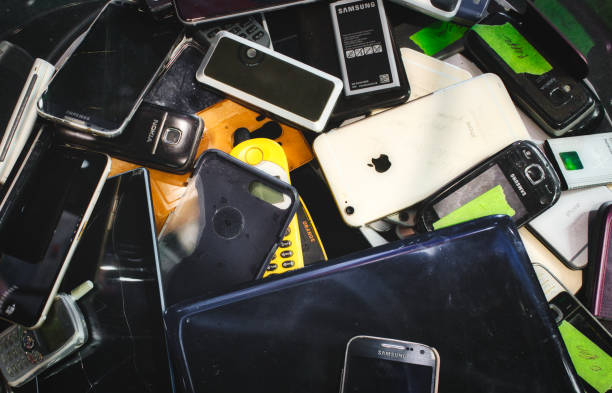 Broken mobile digital devices in a bin to be recycled Mosta / Malta - May 11, 2019: Broken mobile digital devices in a bin to be recycled e waste photos stock pictures, royalty-free photos & images