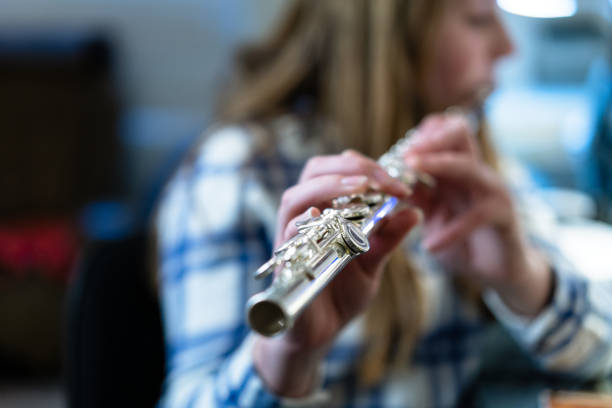 istock Girl Practicing Playing Flute Musical Instrument 1204249906