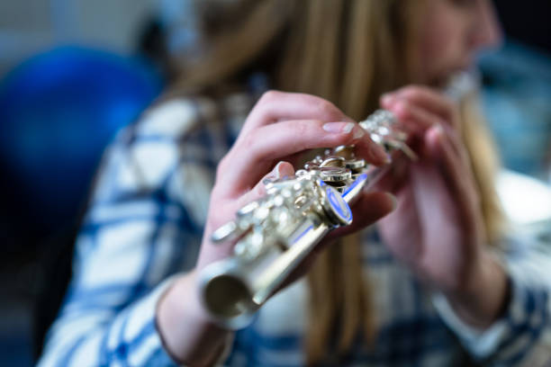 istock Girl Practicing Playing Flute Musical Instrument 1204250051