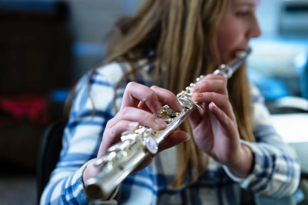 istock Girl Practicing Playing Flute Musical Instrument 1204250642