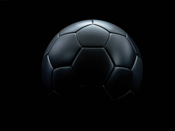 istock Black football against black background. 1204250808