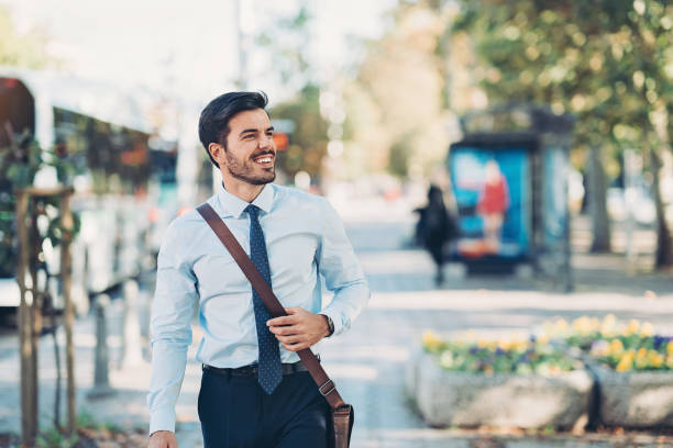 istock Young businessman walking on the sidewalk 1204252135