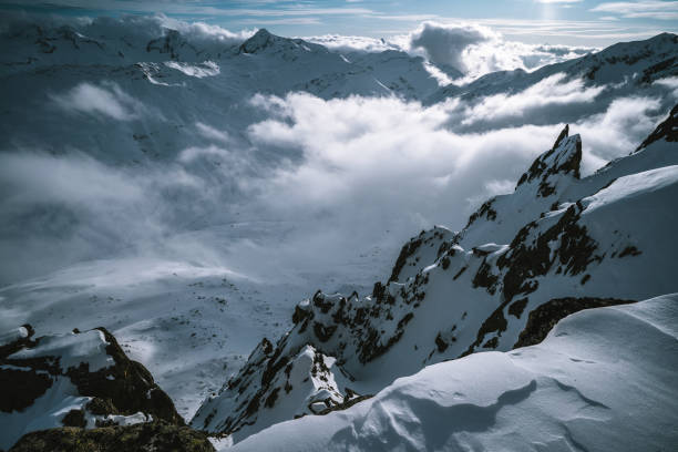 istock Scenic view of mountain ranges with lofty clouds below 1204254991