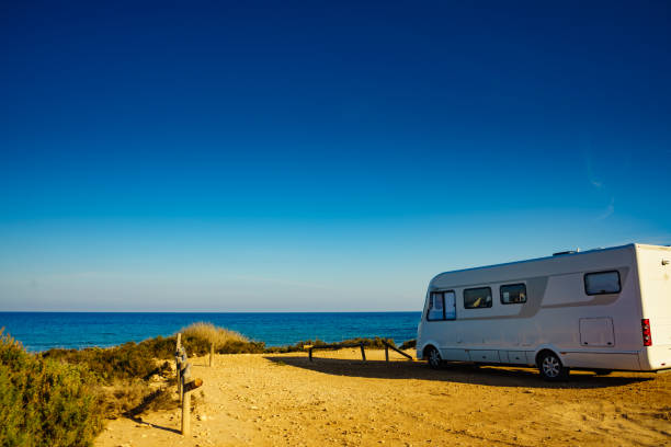 istock Camper car on beach, camping on nature 1204255332