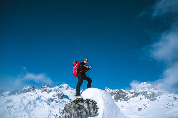 istock Ski mountaineer ascends snowy mountain ridge line 1204256379