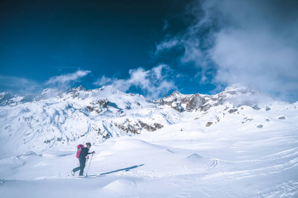 istock Ski mountaineer ascends snowy mountain ridge line 1204256385