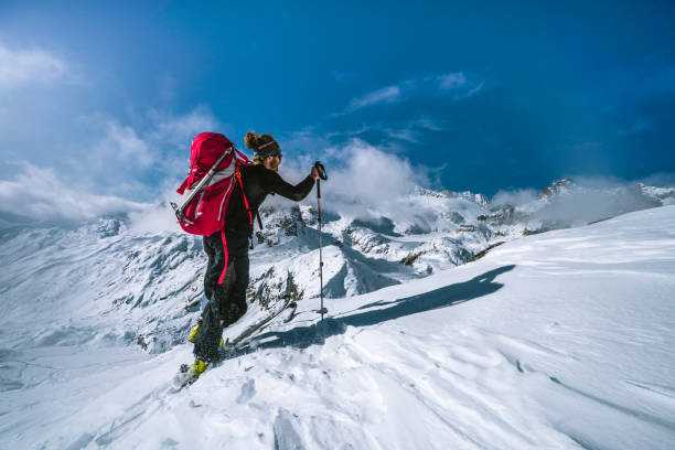istock Ski mountaineer ascends snowy mountain ridge line 1204256454