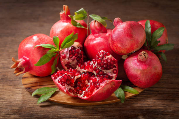 istock fresh ripe pomegranates on a wooden table 1204256509