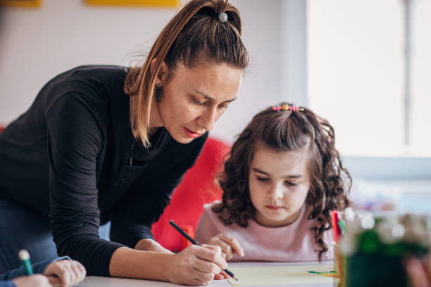 istock Girl writing in preschool 1204258576