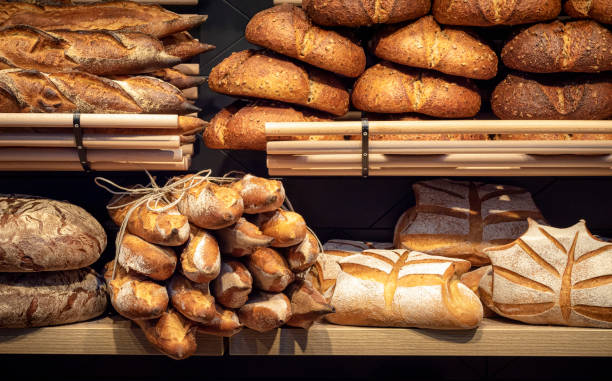 Bread assortment on bakery wooden shelves. Bread shop