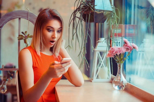 istock Single amazed girl watching content on a smart phone at home 1204261382