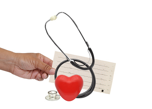 Red heart, Stethoscope and hand holding EKG on white background