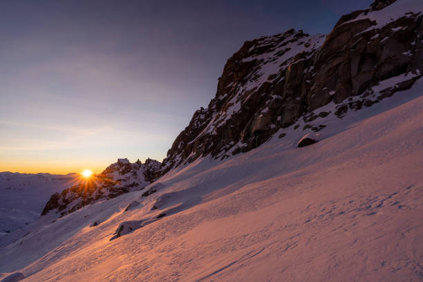 Winter sunrise over dramatic snowy mountains