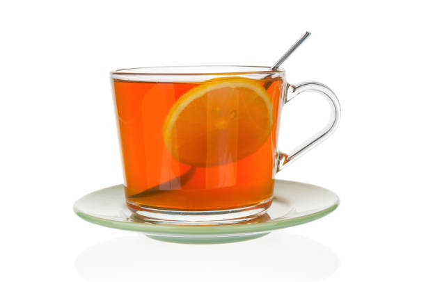 istock Tea with lemon in tea cup close up isolated on white background 1204262948
