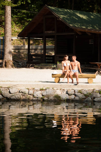 istock Active couple rests on river bank on a hot summer day 1204264233
