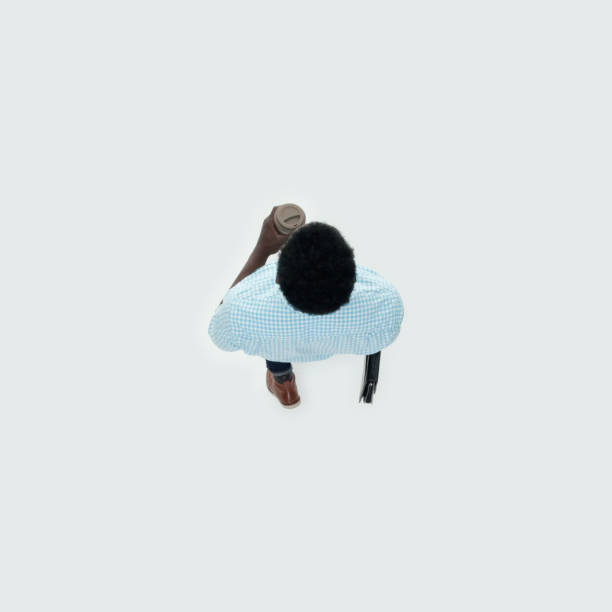 istock Caucasian male walking and holding coffee cup 1204265673