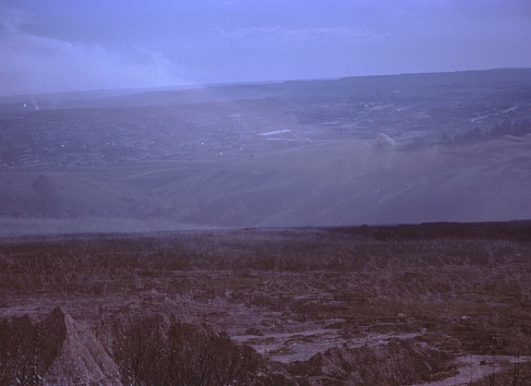 Vernacular photograph taken on a 35mm analog film transparency, believed to depict green grass field near mountain during daytime, 1965. Major topics/objects detected include Sky, Landscape, Steppe, Sea, Ocean and Nature. (Photo by Smith Collection/Gado/Getty Images)