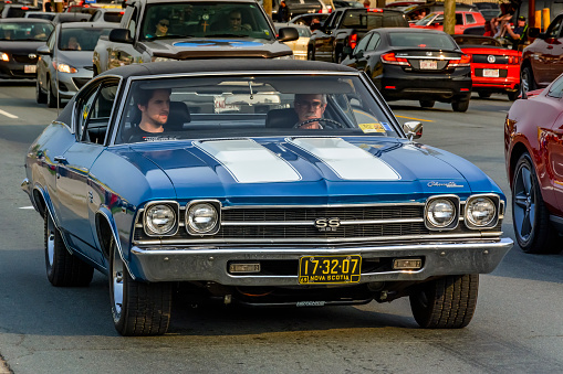 Moncton, New Brunswick, Canada - July 11, 2015 : Driver & passenger cruising in a 1969 Chevrolet Chevelle SS 396 Saturday evening on Mountain Road during 2015 Atlantic Nationals Automotive Extravaganza.
