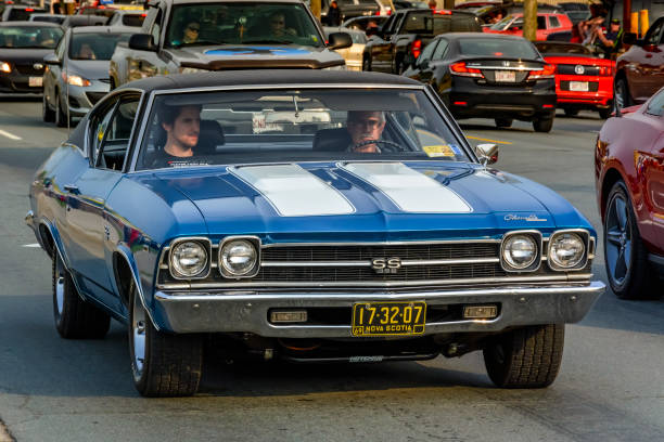 1969 Chevrolet Chevelle SS 396 Moncton, New Brunswick, Canada - July 11, 2015 : Driver & passenger cruising in a 1969 Chevrolet Chevelle SS 396 Saturday evening on Mountain Road during 2015 Atlantic Nationals Automotive Extravaganza. 1969 stock pictures, royalty-free photos & images