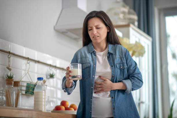 istock Woman having a stomach ache after drinking milk 1204266691