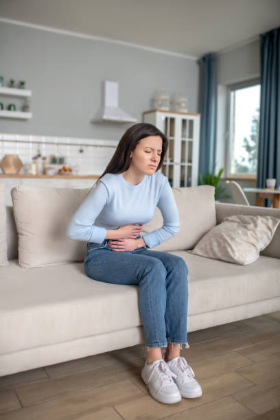 istock Young woman having a strong shomach ache 1204267340