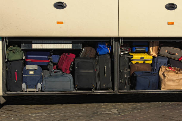 various sizes and colors of suitcases in the cargo compartment of the bus. close-up view of full place for luggage in the bus. travel and vacation concept - compartimento de armazenamento imagens e fotografias de stock