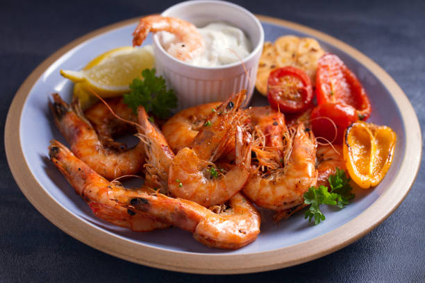 istock Shrimps with sauce, lemon and vegetables. Seafood 1204269843