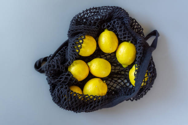 istock black shopping net with fresh lemons 1204270663