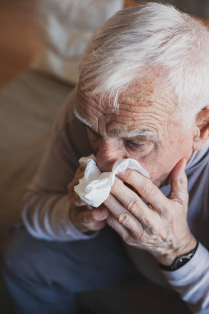 istock Senior man have allergy and blowing nose with tissue 1204271056