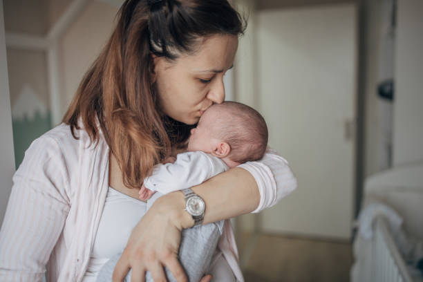 istock Mother kissing her son 1204271153