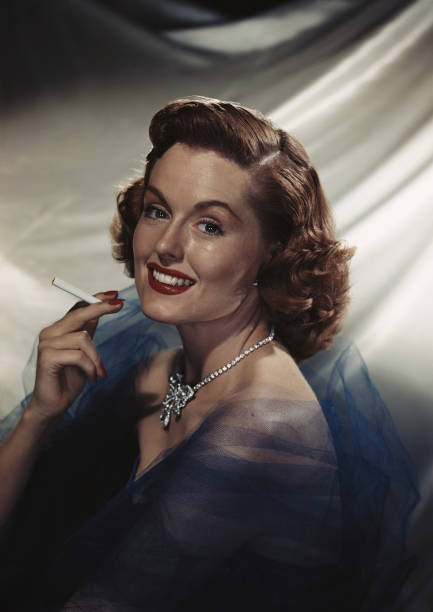 Woman holding cigarette, smiling, portrait  cigarette photos stock pictures, royalty-free photos & images