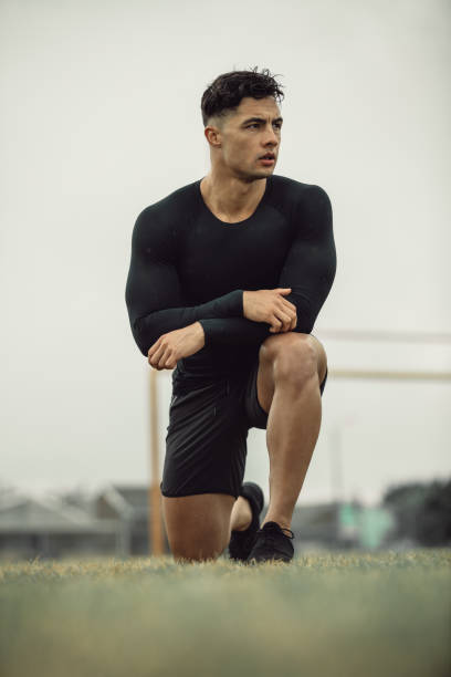 istock Athlete resting during morning workout on field 1204271474