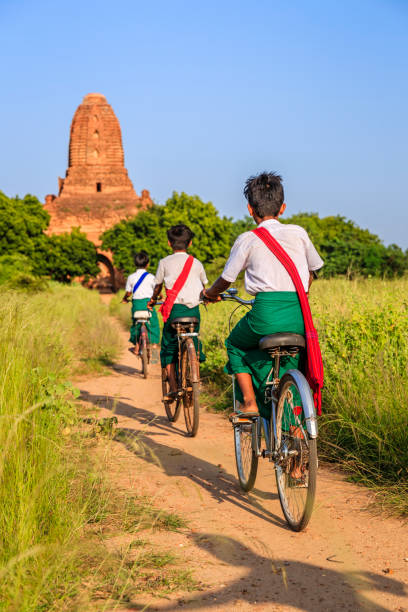 istock Burmese school children riding a bicycle in Bagan, Myanmar 1204272181