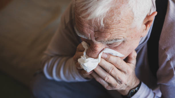 istock Senior man have allergy and blowing nose with tissue 1204272311