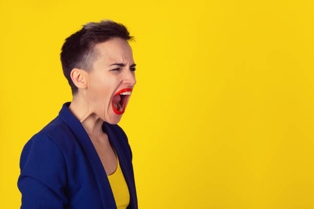 profilo ritratto arrabbiato donna sconvolta urlando piangendo bocca spalancata faccia isterica smorfia isolato sfondo muro giallo. reazione emotiva dell'espressione umana negativa. concetto di confronto dei conflitti - mouth open women displeased anger foto e immagini stock