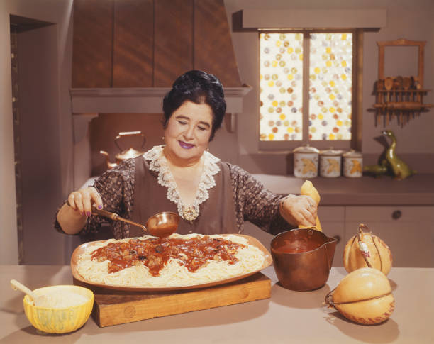 Woman preparing spaghetti dish with sauce in kitchen large pasta pot stock pictures, royalty-free photos & images