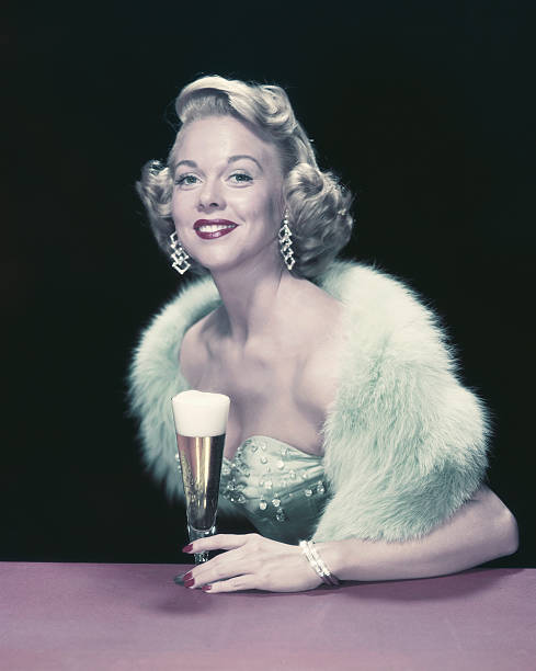 jovem mulher segurando um copo de cerveja, sorriso, retrato - 1955 - fotografias e filmes do acervo