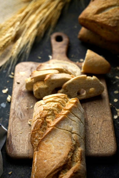 istock Fresh Baguette Bread Loaf Cut into Slices 1204272782