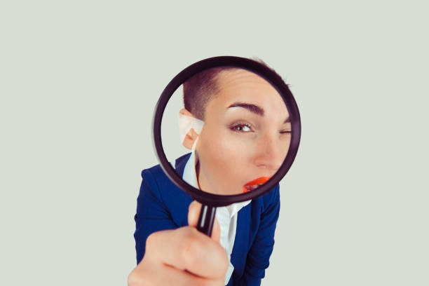 bad vision. woman business girl with magnifying glass lens trying to see through it isolated light green white background. - magnifying glass lens holding europe imagens e fotografias de stock