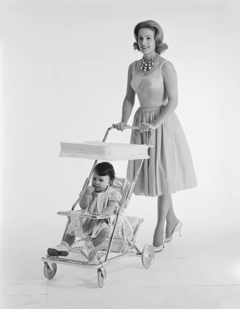 Baby sitting in pram and mother pushing  carriage photos stock pictures, royalty-free photos & images