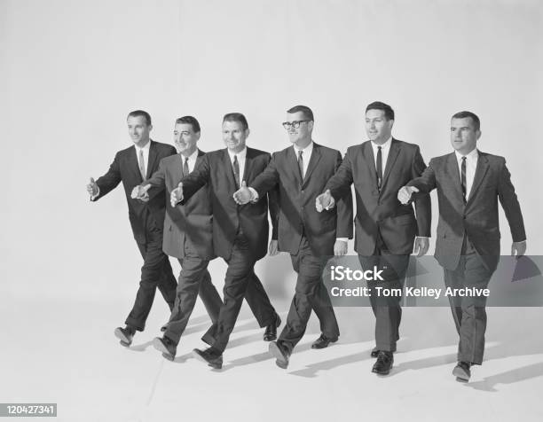 Businessmen Extending Hand To Shake Smiling Stock Photo - Download Image Now - Archival, Businessman, Only Men