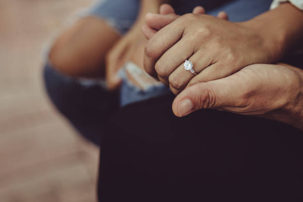istock Married couple sitting together holding hands 1204273999