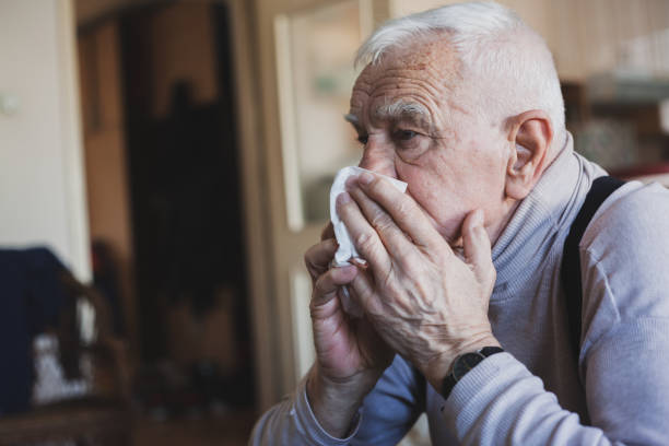 istock Senior man have allergy and blowing nose with tissue 1204274439