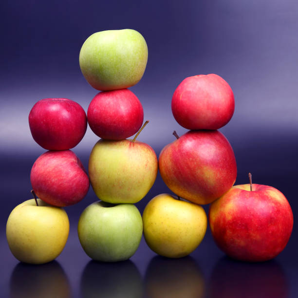 istock Wall of fresh different apples on dark background 1204274757
