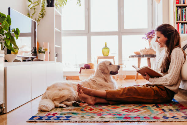 beautiful woman enjoying a cup of coffee during healthy breakfast at home. writing on notebook. adorable golden retriever dog besides. lifestyle indoors - blueberry fruit berry berry fruit imagens e fotografias de stock