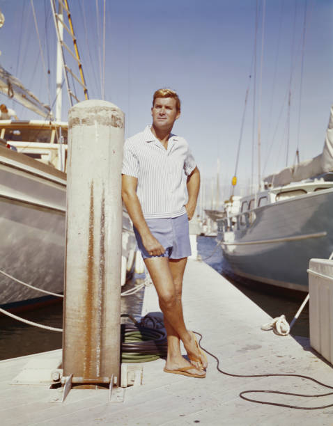 Young man standing at harbour  moored photos stock pictures, royalty-free photos & images